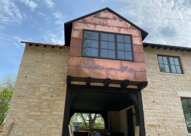 Copper metal panel facade on a stone building for Skylight Installation in LaGrange